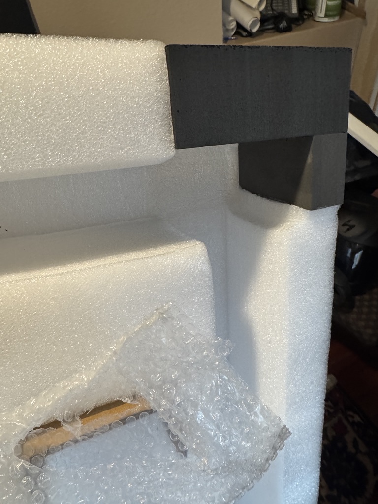 Custom molded foam cradles and bubble wrap protecting Autonomous Desk Pro components